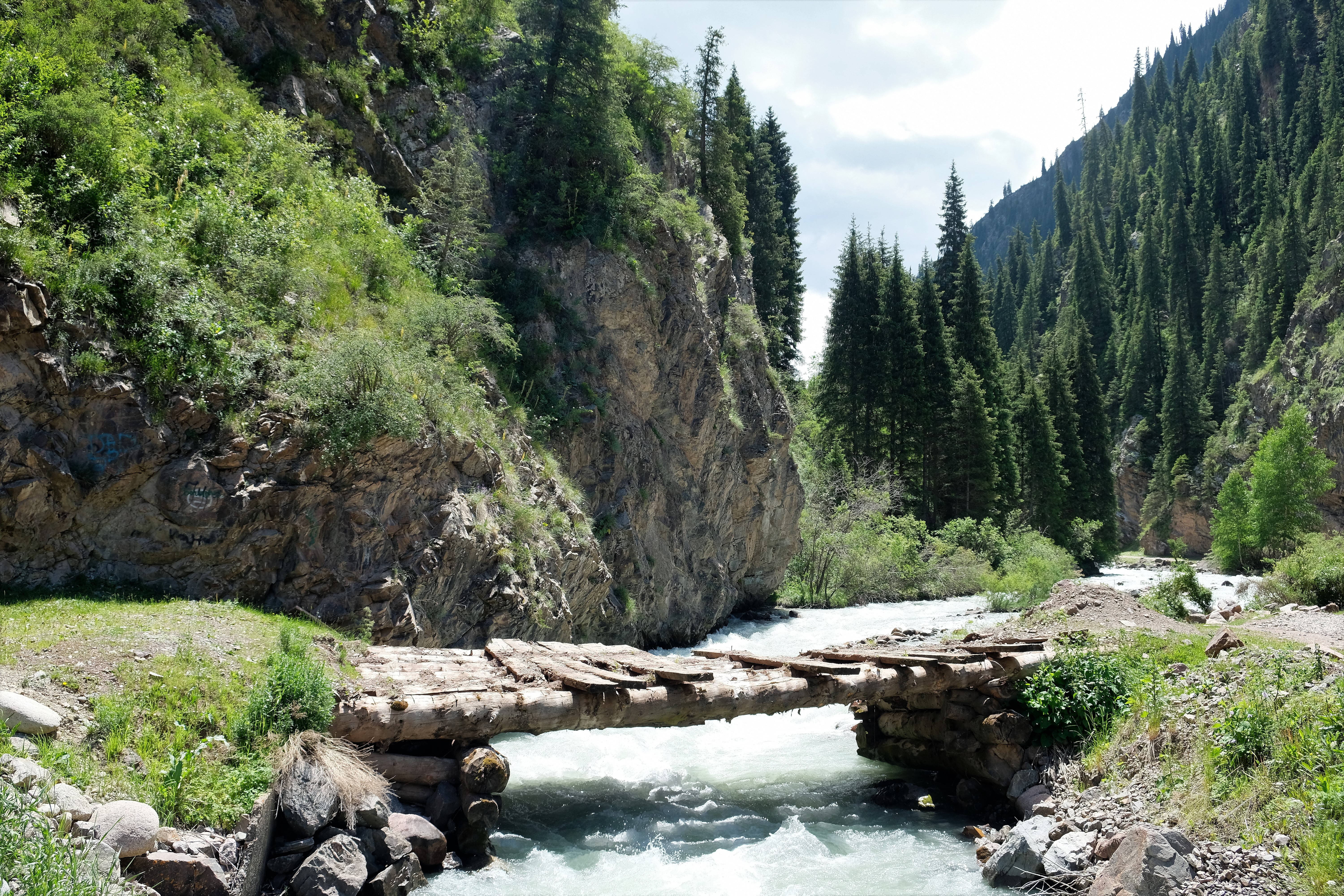 a woodenbridge over a rvver on the way to the valley of flowers