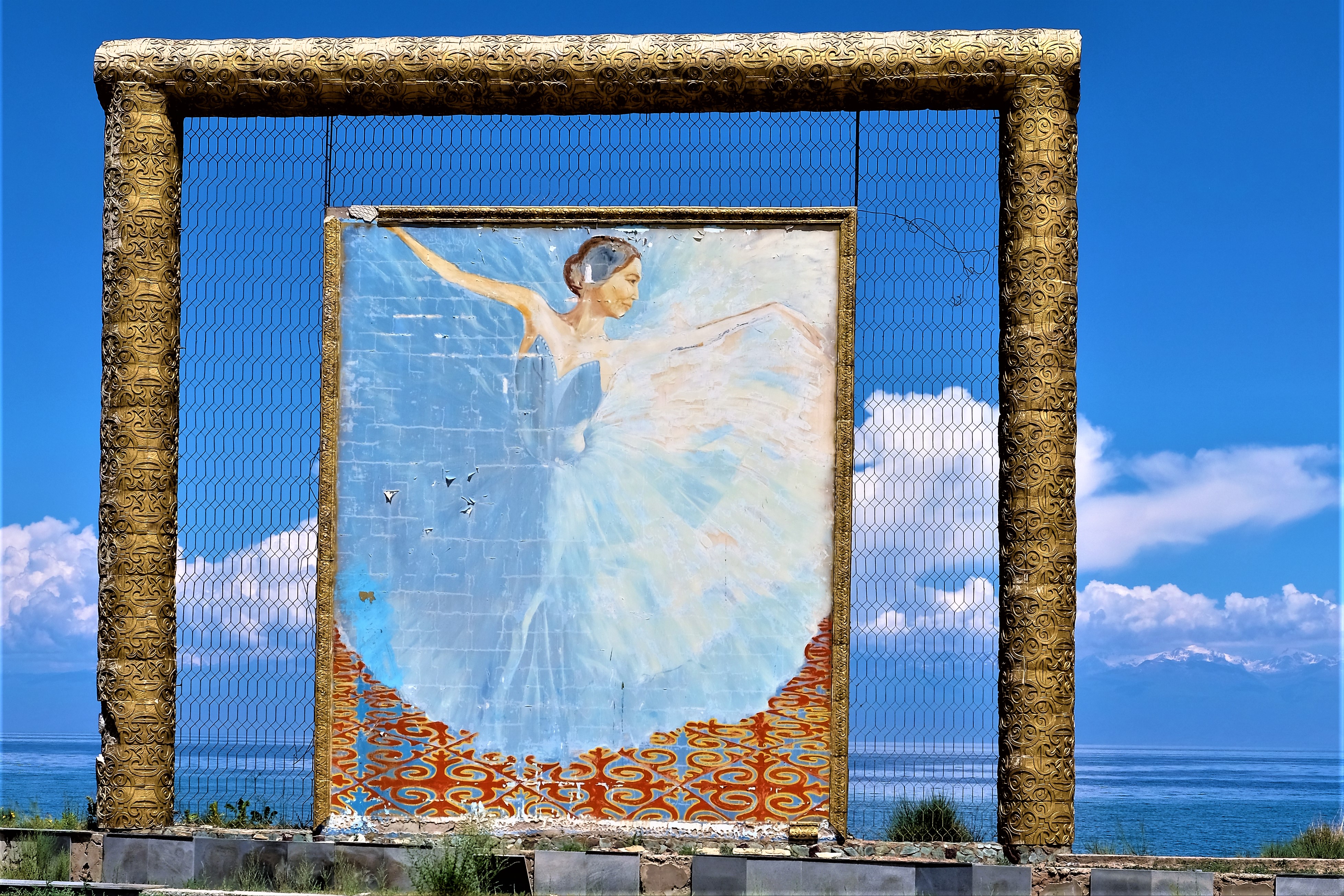 A picture of a dancing ballerina with lake Issyk Kul in the background